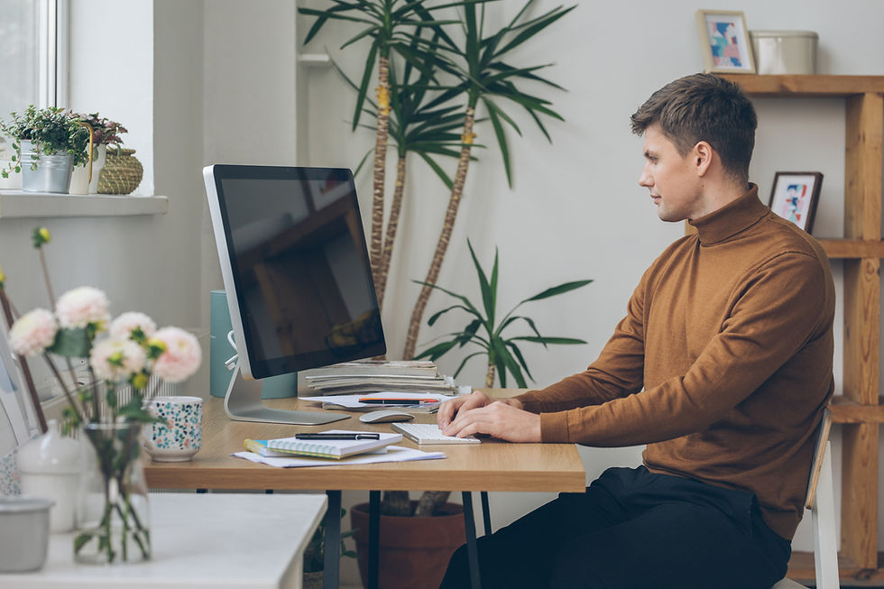 man sitting at desktop computer